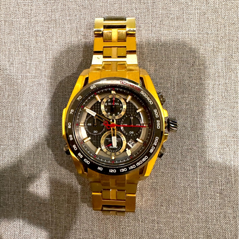 Gold Bulova Precisionist watch